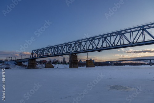 railway bridge winter. Railway bridge over the river. Steel structure, railway.