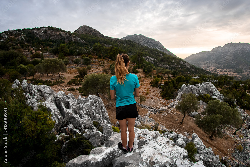 rear view of woman on mountain who enjoying mountains landscape. Hiking travel on lycian way