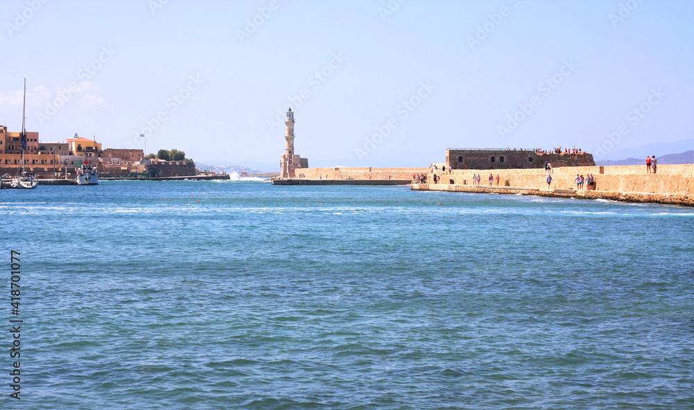 A harbor bay at the old Venetian harbor of Chania on Crete, Greece. View of the stone breakwater and the lighthouse 
