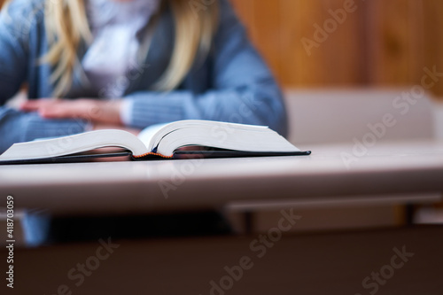 book on table Girl at her desk reading book, selective focus