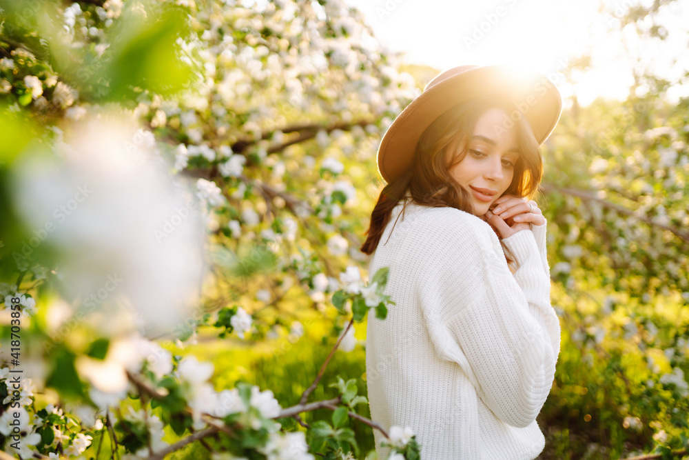 Young woman enjoying scent in blooming spring garden. The concept of youth, love, fashion and lifestyle. Young woman enjoying scent in blooming spring garden. The concept of youth, love, fashion and lifestyle.