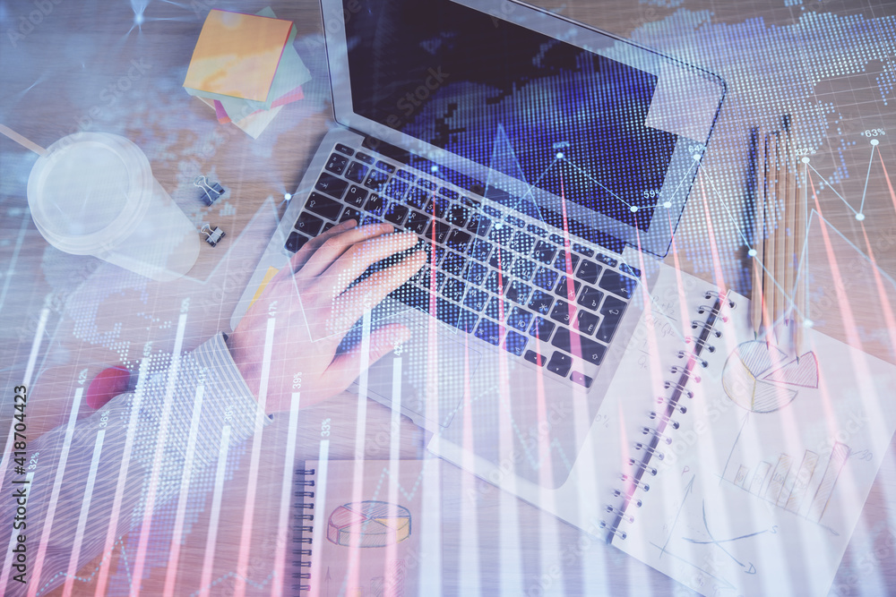 Double exposure of man's hands typing over computer keyboard and forex graph hologram drawing. Top view. Financial markets concept. Double exposure of man's hands typing over computer keyboard and forex graph hologram drawing. Top view. Financial markets concept.
