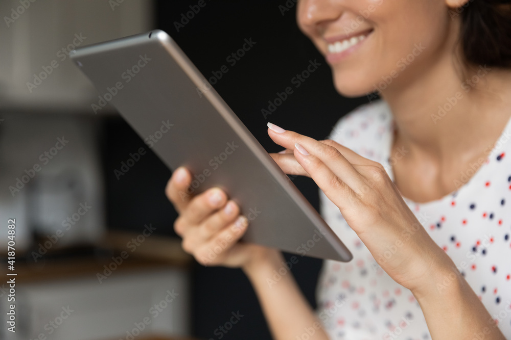 Cropped shot of smiling woman student employee freelancer hand hold electronic tablet use modern device for work study online. Happy young lady touch sensor screen of digital pad watch video. Close up Cropped shot of smiling woman student employee freelancer hand hold electronic tablet use modern device for work study online. Happy young lady touch sensor screen of digital pad watch video. Close up