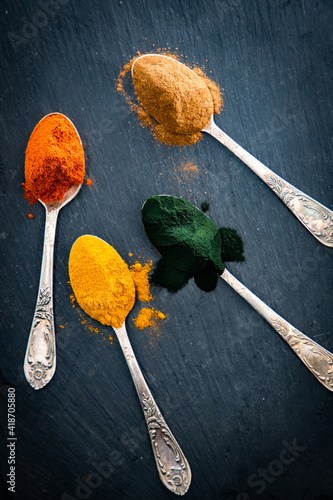 spirulina ginger turmeric powder in spoons superfoods