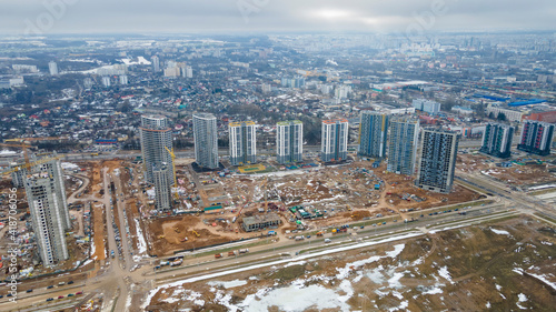 Construction of high-rise resedential buildings. The construction industry with working equipment. View from above. Eye bird view of new resedential district. photo