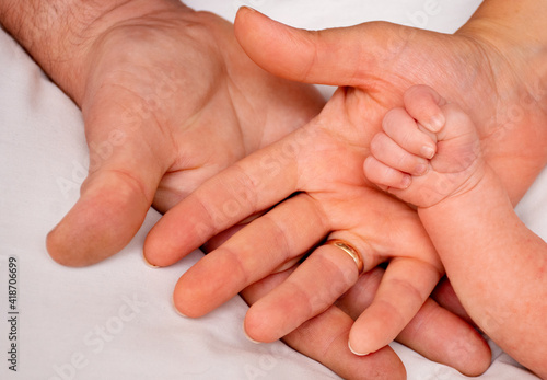 hands of the family, child, mother and father. The concept of unity, support, protection and happiness.