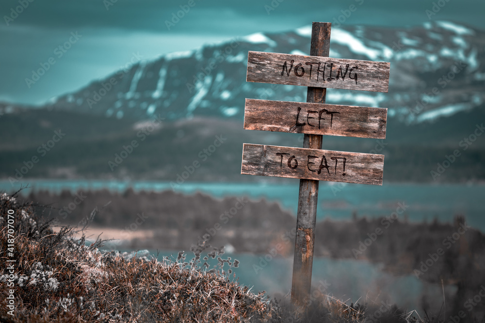 Ταπετσαρία nothing left to eat text quote engraved on wooden signpost outdoors in landscape looking polluted and apocalyptic
