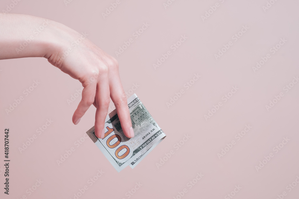 Female hand holding banknotes. Money and finance concept with copy space Female hand holding banknotes. Money and finance concept with copy space