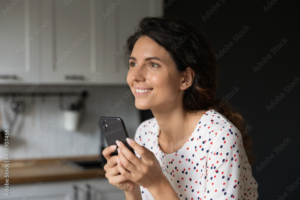 Fallen in love. Happy millennial woman texting with beloved man at social network using cell look aside dream of dating. Young lady motivated with good news at phone message visualize success in mind Fallen in love. Happy millennial woman texting with beloved man at social network using cell look aside dream of dating. Young lady motivated with good news at phone message visualize success in mind