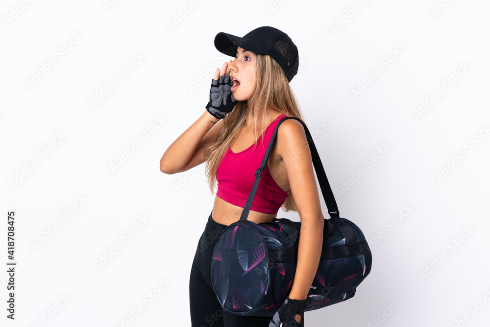 Young sport woman with sport bag over isolated white background shouting with mouth wide open to the side Young sport woman with sport bag over isolated white background shouting with mouth wide open to the side