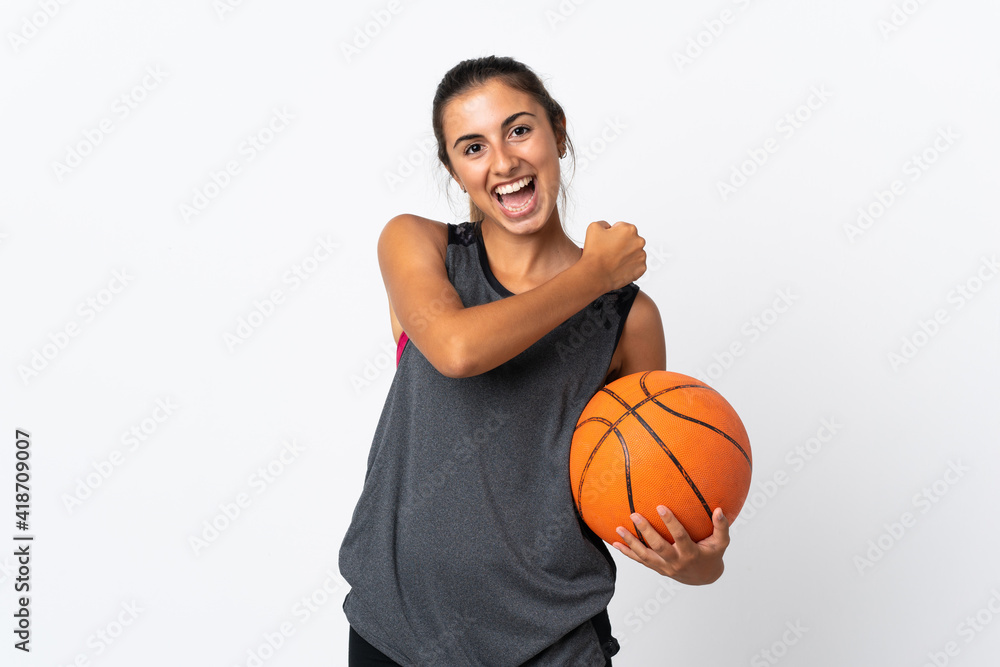 Young hispanic woman playing basketball over isolated white background celebrating a victory Young hispanic woman playing basketball over isolated white background celebrating a victory