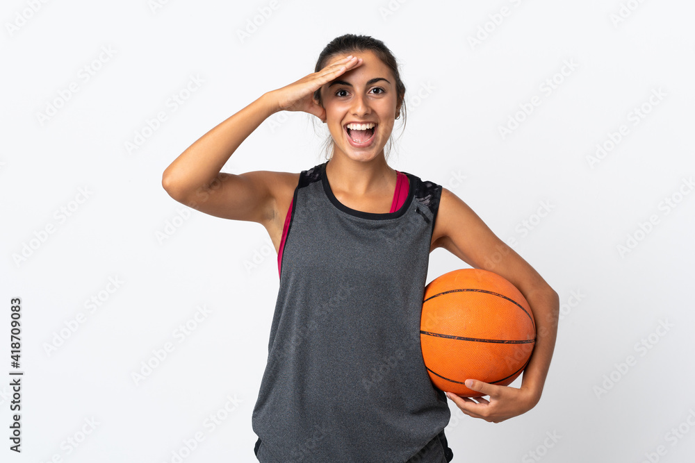 Young hispanic woman playing basketball over isolated white background with surprise expression