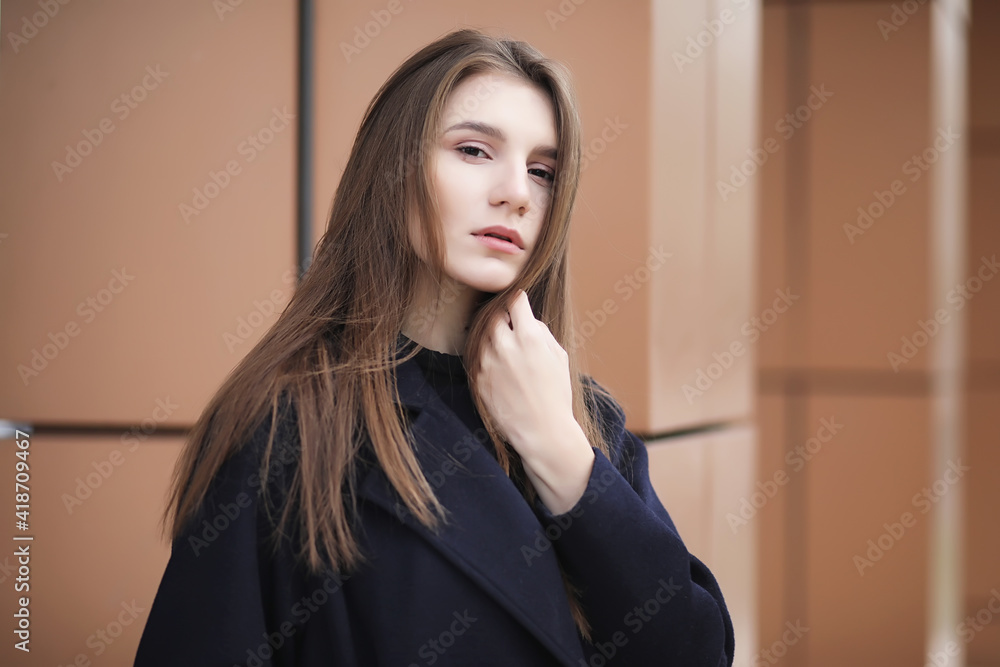Beautiful girl in a coat in business downtown Beautiful girl in a coat in business downtown