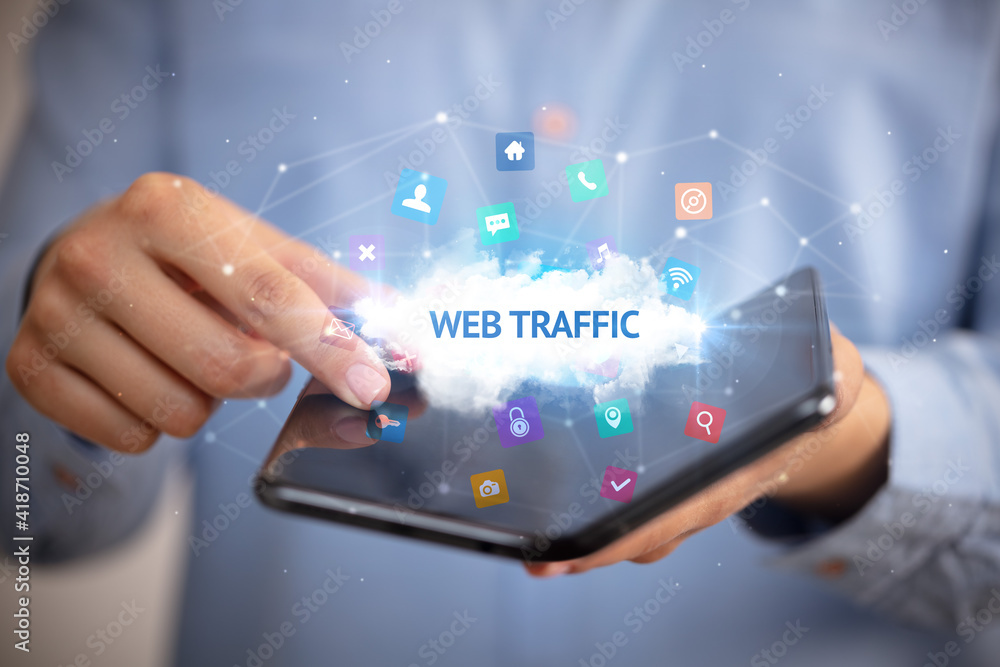 Businessman holding a foldable smartphone with WEB TRAFFIC inscription, technology concept Businessman holding a foldable smartphone with WEB TRAFFIC inscription, technology concept