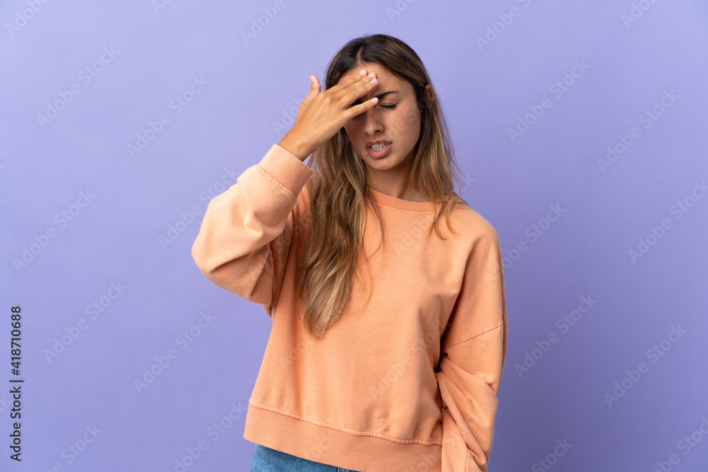 Young hispanic woman over isolated purple background with headache Young hispanic woman over isolated purple background with headache