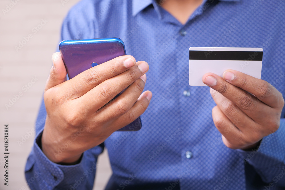 online payment with credit card. holding credit card and using smart phone online payment with credit card. holding credit card and using smart phone