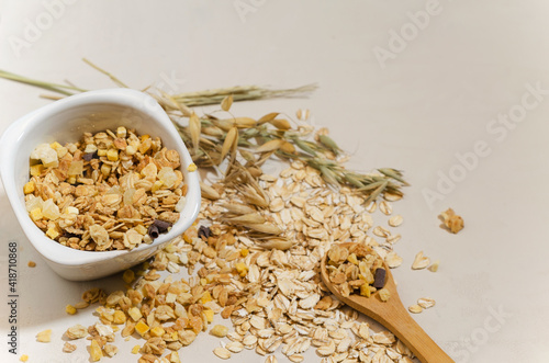 Healthy wholesome breakfast granola on beige background, selective focus, copy text
