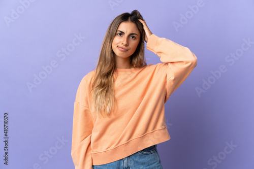 Young hispanic woman over isolated purple background with an expression of frustration and not understanding