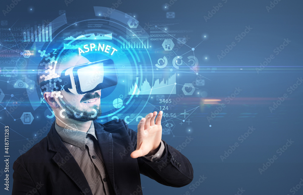 Fototapeta premium Businessman looking through Virtual Reality glasses with ASP.NET inscription, innovative technology concept