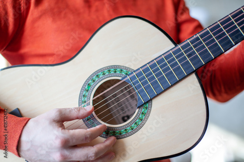 Close-up of a guitar player or a person learning to play the guitar.