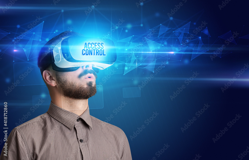 Businessman looking through Virtual Reality glasses with ACCESS CONTROL inscription, cyber security concept Businessman looking through Virtual Reality glasses with ACCESS CONTROL inscription, cyber security concept