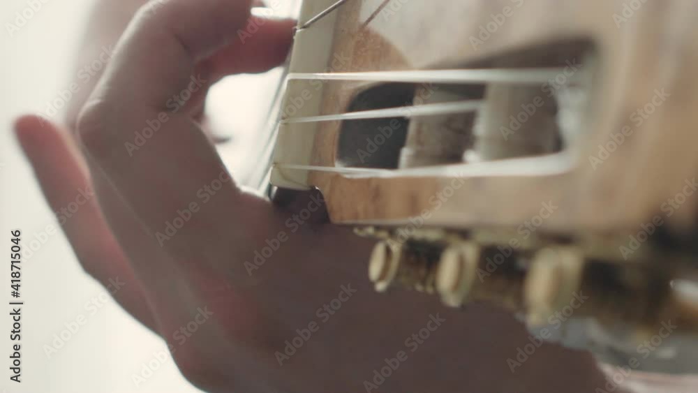 man plays the classical guitar close-up. musician's rehearsal