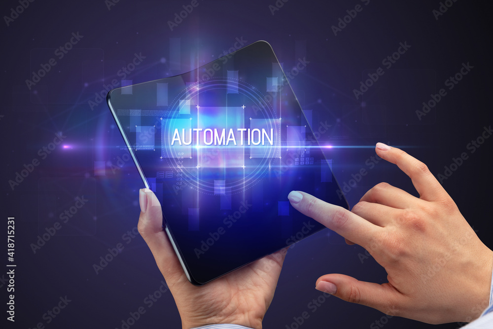 Obraz premium Businessman holding a foldable smartphone with AUTOMATION inscription, new technology concept
