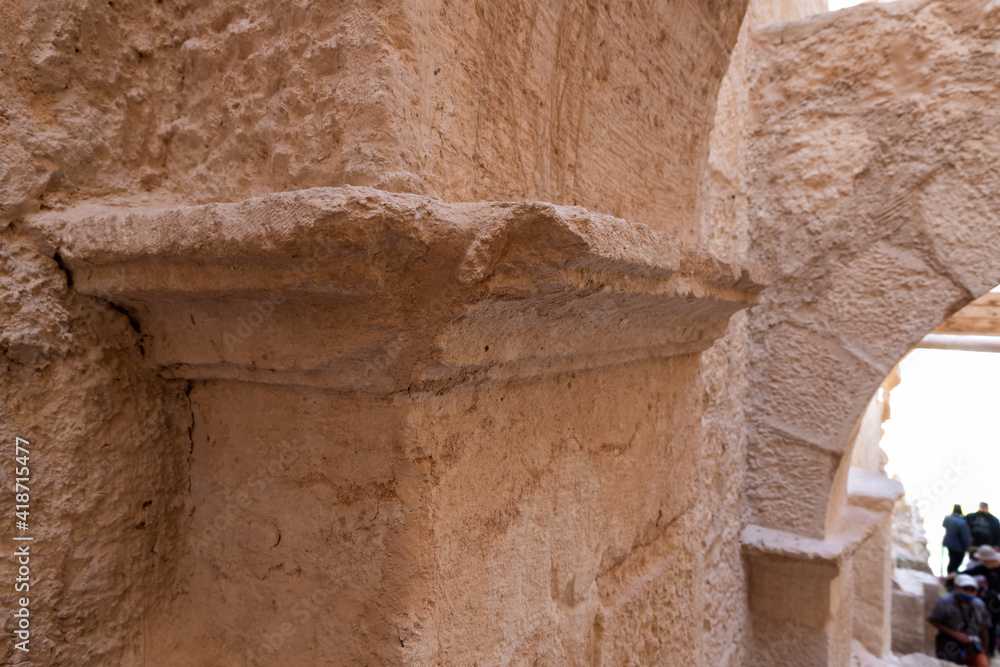A fragment  of a well-preserved decorative ornament on a pillar at the entrance to the ruins of the palace of King Herod - Herodion in the Judean Desert, in Israel