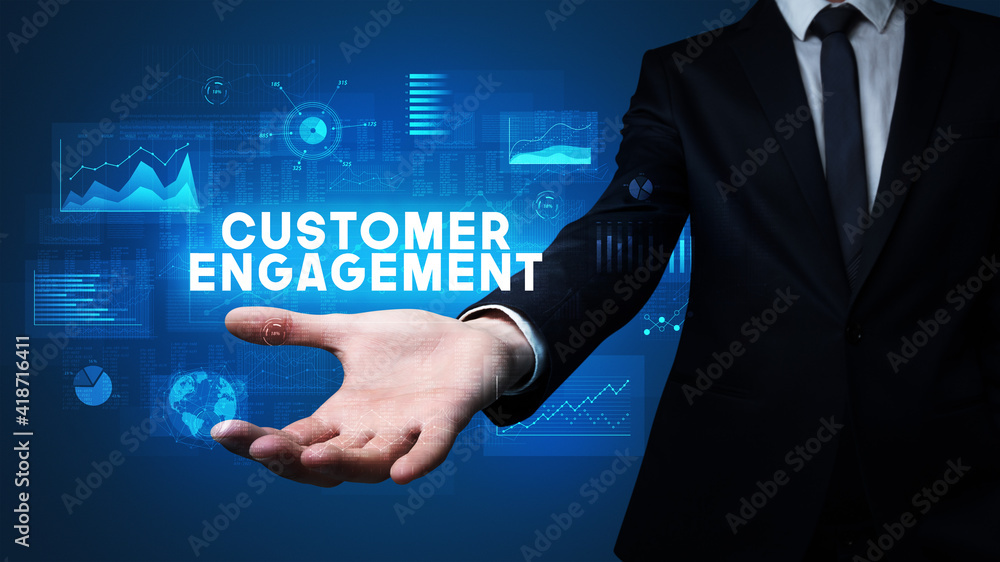 Hand of Businessman holding CUSTOMER ENGAGEMENT inscription, business success concept Hand of Businessman holding CUSTOMER ENGAGEMENT inscription, business success concept