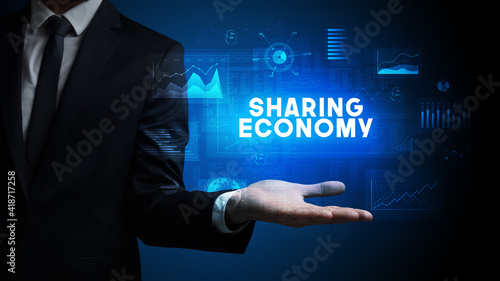 Wallpaper Mural Hand of Businessman holding SHARING ECONOMY inscription, business success concept Torontodigital.ca