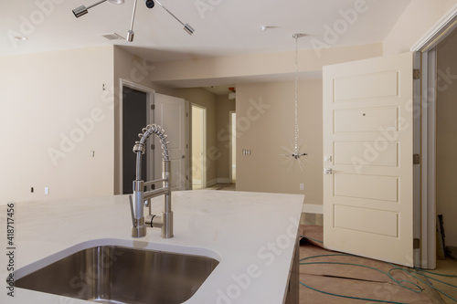 Interior design bright modern kitchen with stainless steel sink tap with island sink