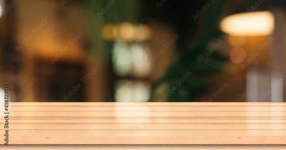 Empty wooden table top with lights bokeh on blur restaurant background. Empty wooden table top with lights bokeh on blur restaurant background.