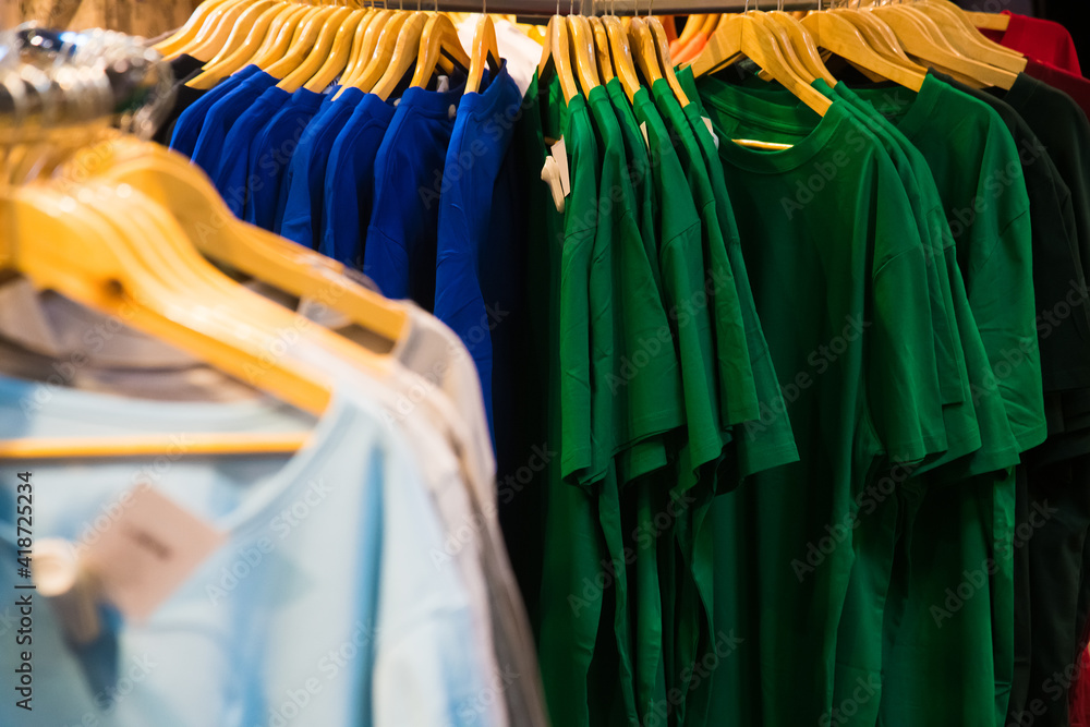 Fototapeta premium T-shirts on hangers in the store