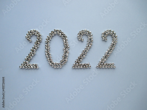 2020 on a gray background. 2020 is assembled from silver bells. 