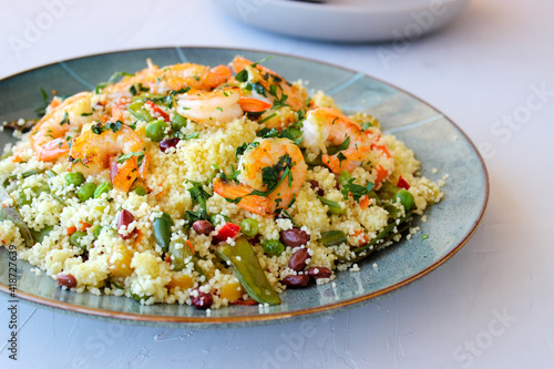 Couscous with vegetables and king prawns.