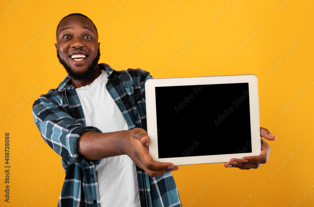 Joyful African Man Showing Empty Digital Tablet Screen, Yellow Background Joyful African Man Showing Empty Digital Tablet Screen, Yellow Background