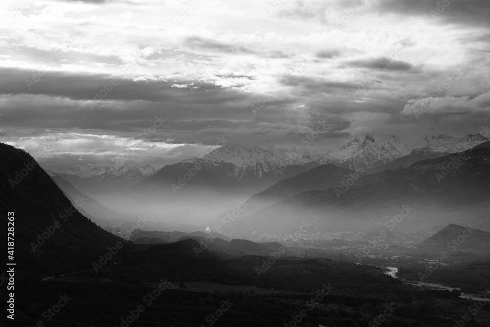 Dramatic sky over the mountains. Black and white landscape photography