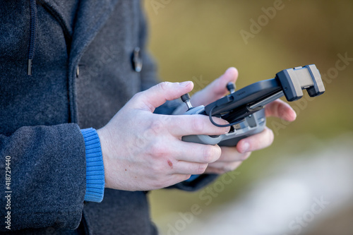 person holding controller of drone photo