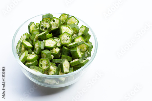 Fresh okra in glass bowl isolated on white