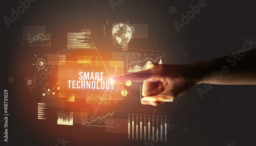 Hand touching SMART TECHNOLOGY inscription, new business technology concept