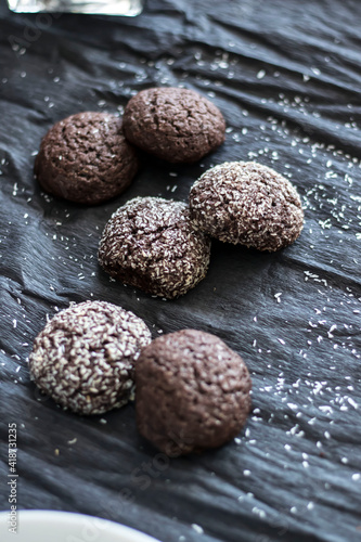 Chocolate chip cookies with coconut. Lie on a black and gray background. © Margo