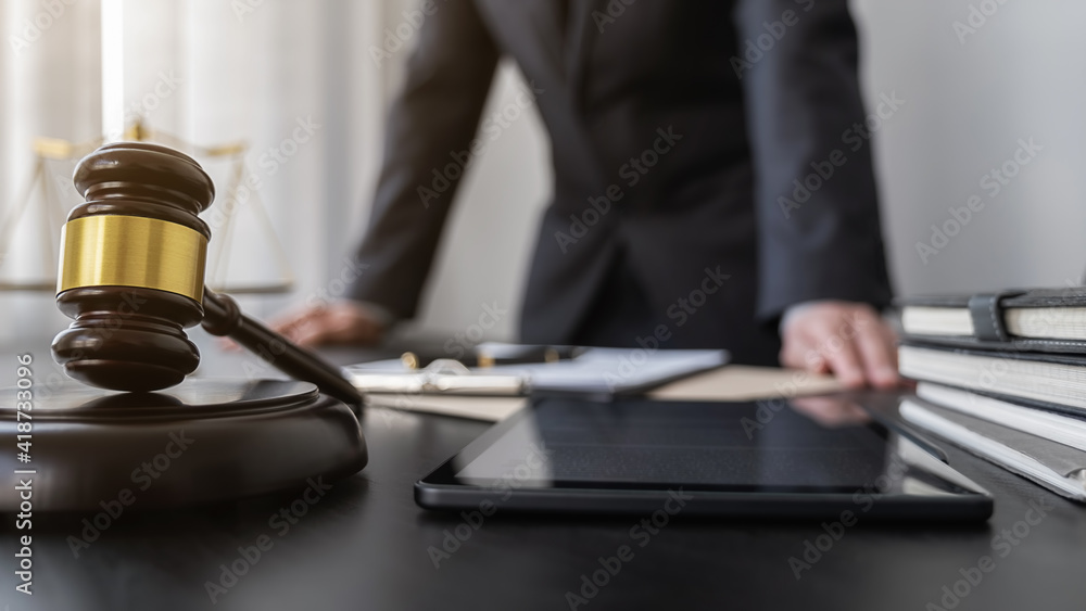 Professional lawyer considering with contract papers in courtroom. Justice, Law, Attorney and Court judge concept. Professional lawyer considering with contract papers in courtroom. Justice, Law, Attorney and Court judge concept.