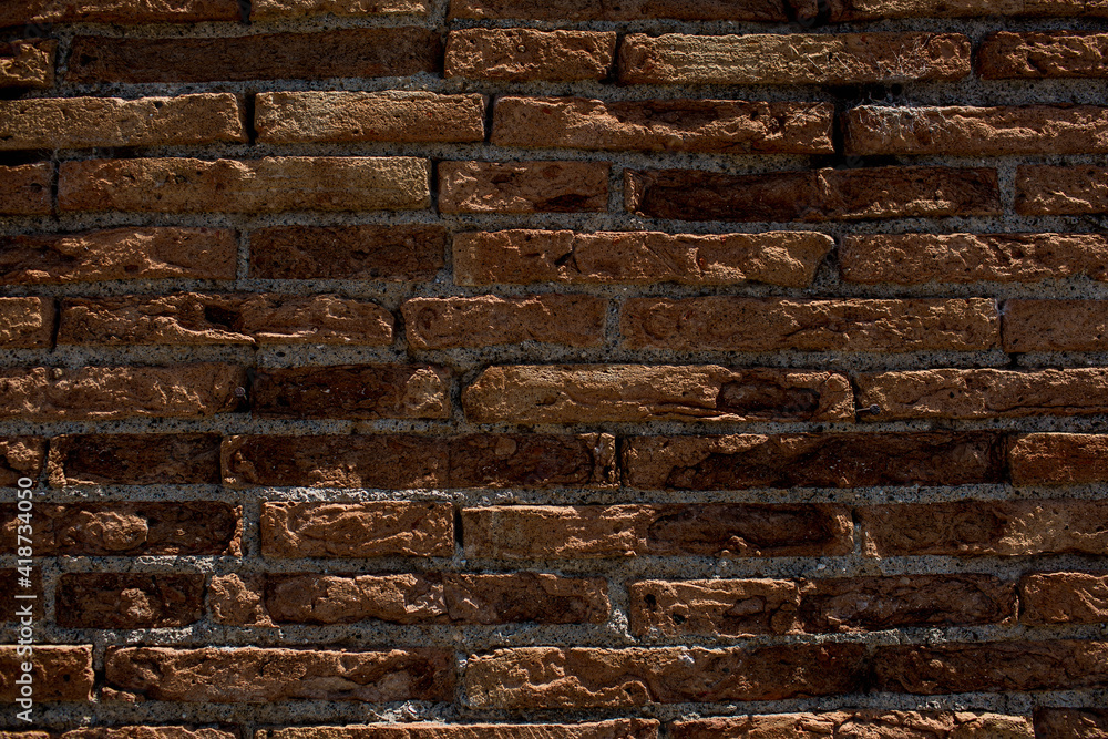 Old grungy rustic dirty dusty brick wall of ancient city. Uneven pitted peeled surface brickwork of cellar worn.Ruined rusty red stiff blocks. Spotted messy ragged holes brickwall for 3D grunge design