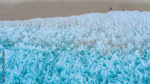 Aerial view of sandy beach with tourists in beautiful abstract the sea wave