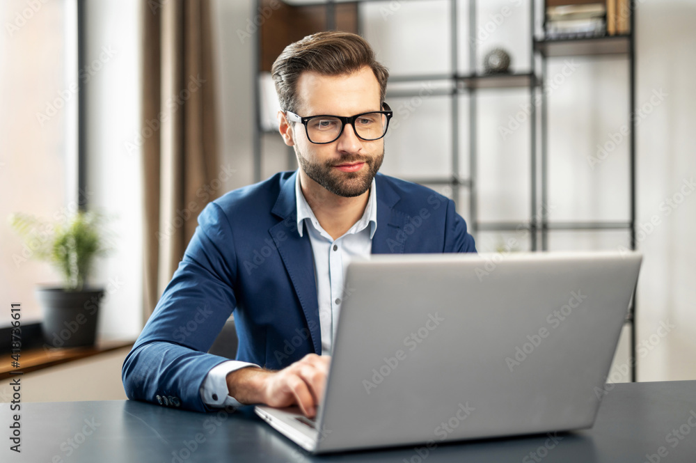 Relaxed man working at contemporary office, typing on keyboard, sitting on comfy chair, feels serenity, enjoy fresh conditioned air, no stress, fatigue relieve at workplace concept, great atmosphere Relaxed man working at contemporary office, typing on keyboard, sitting on comfy chair, feels serenity, enjoy fresh conditioned air, no stress, fatigue relieve at workplace concept, great atmosphere
