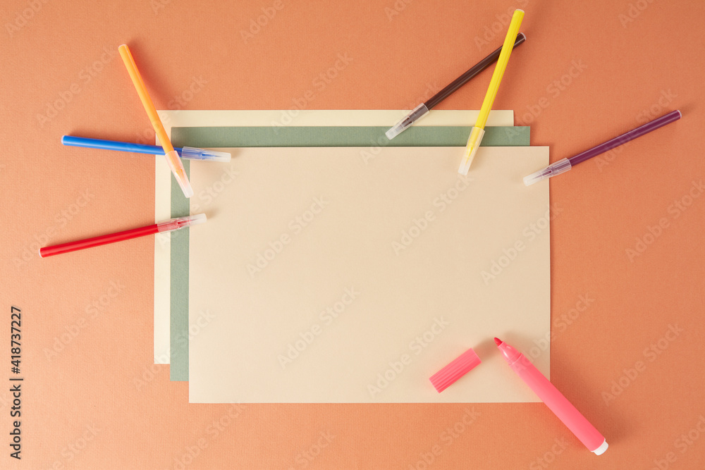 Colorful back to school flat lay and clipboard on brown background Colorful back to school flat lay and clipboard on brown background