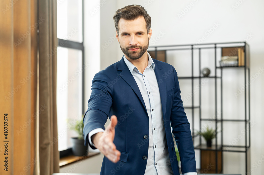 Confident businessman dressed in suit, handshake for teamwork of business merger and acquisition, successful negotiate, hand shake with partner to celebration partnership and business deal concept Confident businessman dressed in suit, handshake for teamwork of business merger and acquisition, successful negotiate, hand shake with partner to celebration partnership and business deal concept