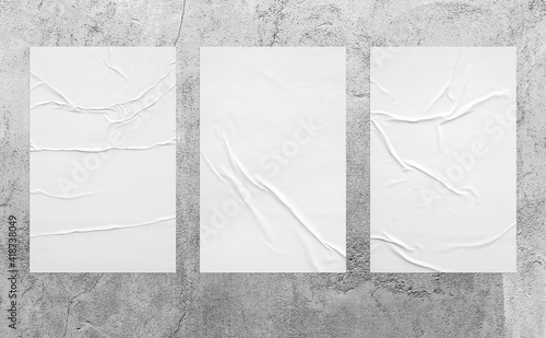 three vertical glued paper on the aged grey wall.  wrinkled texture surface can be used for mockup poster, campaign, promotion in street theme. realistic shabby 3d texture illustration.