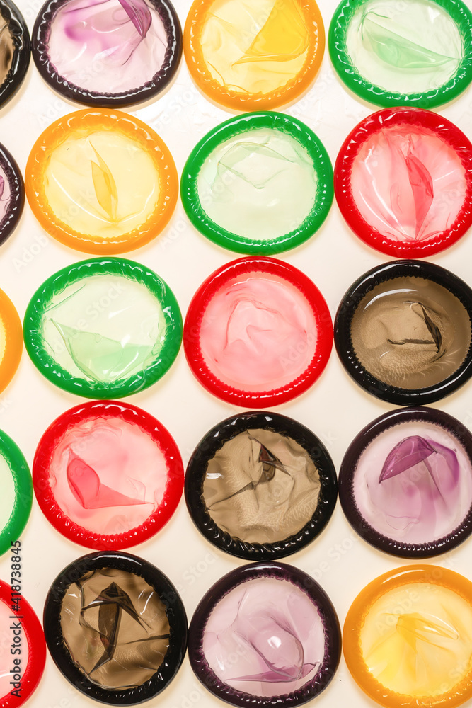 Naklejka premium Colorful condoms background.
