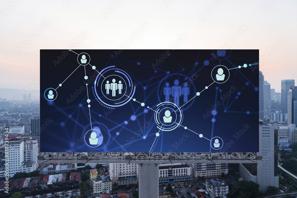 Fototapeta premium Glowing Social media icons on billboard over sunset panoramic city view of Kuala Lumpur, Malaysia, Asia. The concept of networking and establishing new connections between people and businesses in KL